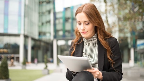 Business woman using a tablet outdoors