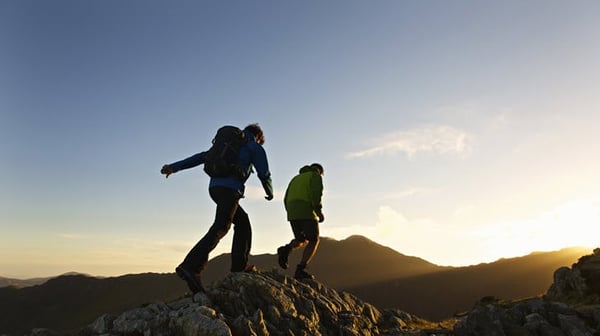 Two men walking on a mountain