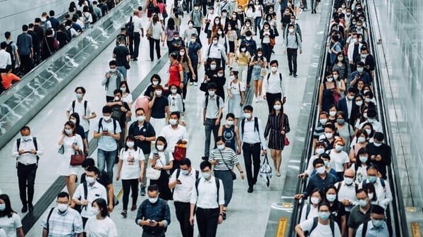 Large crowd walking through transport terminal