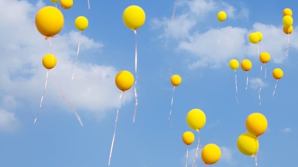 Yellow balloons flying